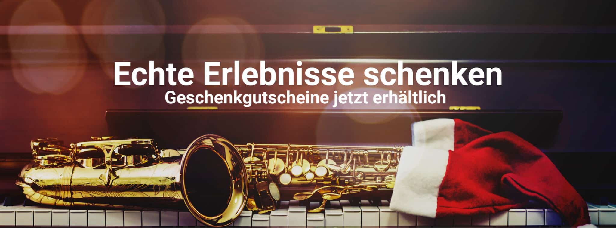 Saxophon auf einer Klavierklaviatur mit Weihnachtsmütze, Hintergrund unscharf, Motiv für Geschenkgutscheine des Jazzfest Bonn.